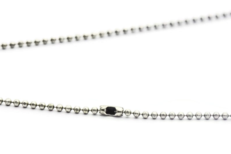May include: A silver ball chain necklace with a silver clasp.