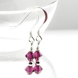 July Ruby Swarovski Crystal Birth Month Sterling Silver Drop Earrings hanging on vase