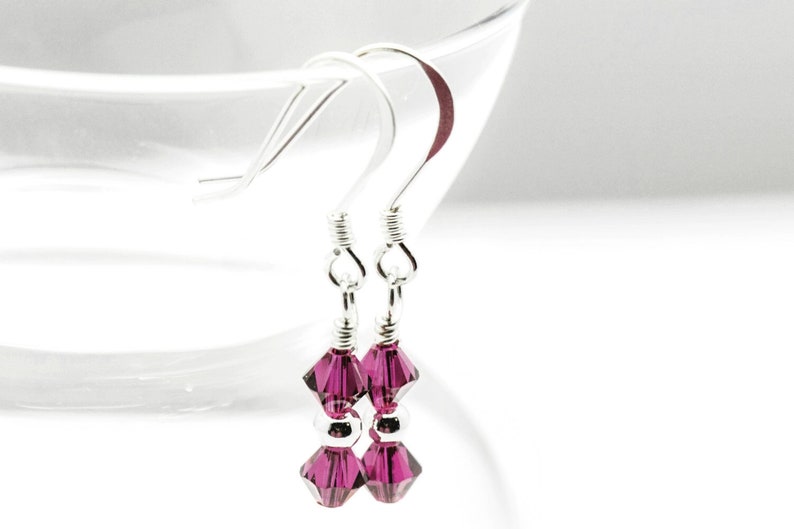 July Ruby Swarovski Crystal Birth Month Sterling Silver Drop Earrings hanging on vase