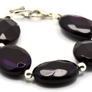 May include: A purple agate gemstone bracelet with silver beads and a silver clasp.