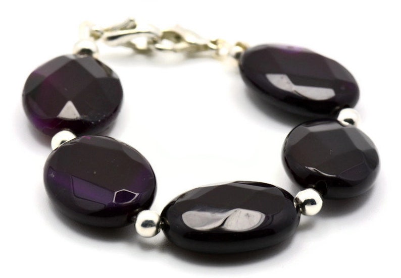 May include: A purple agate gemstone bracelet with silver beads and a silver clasp.