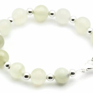 May include: A white and green gemstone bracelet with silver beads and a silver clasp.
