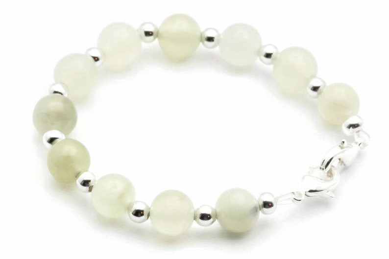May include: A white and green gemstone bracelet with silver beads and a silver clasp.