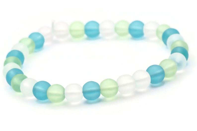 May include: A bracelet made of frosted glass beads in shades of blue, green, and white.