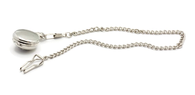 May include: A silver pocket watch with a chain attached. The watch has a round face and a silver chain with a clip.