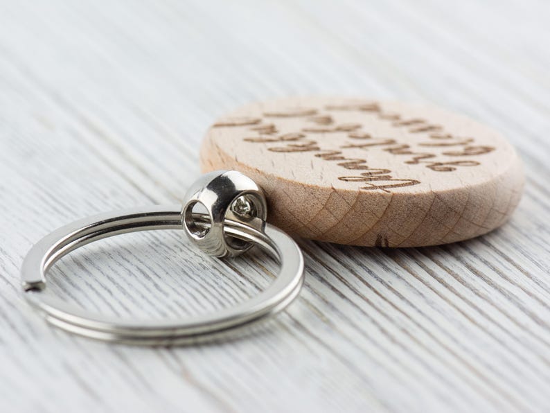 May include: A wooden keychain with a silver ring and the text "You are my sunshine" engraved on the front.