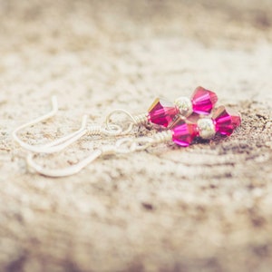 July Ruby Swarovski Crystal Birth Month Sterling Silver Drop Earrings on wood background