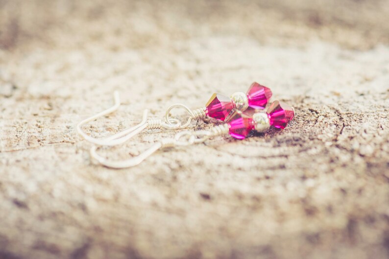 July Ruby Swarovski Crystal Birth Month Sterling Silver Drop Earrings on wood background