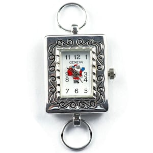 May include: Silver pocket watch with a Santa Claus design on the face. The watch face reads "GENEVA" and has Roman numeral hour markers.