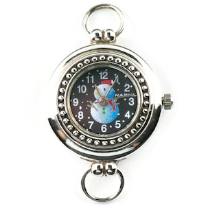 May include: Silver pocket watch with a black face and a snowman design. The watch face has black Roman numeral hour markers and a white background with a snowman in the center. The watch has a silver chain attached to the top.