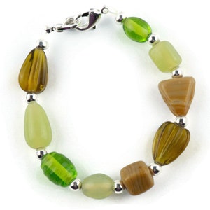 May include: A green, brown and silver beaded bracelet with a silver clasp.