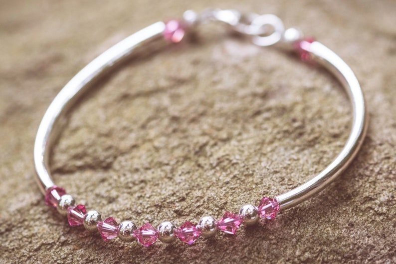 October Rose Swarovski Crystal Birth Month Sterling Silver Plated Bracelet on stone