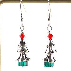 May include: Silver Christmas tree earrings with red and green crystal accents.