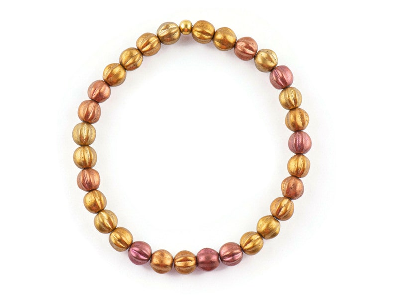 May include: A gold and copper toned beaded bracelet with a gold clasp.