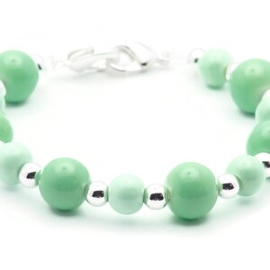 May include: A green and silver beaded bracelet with a silver clasp.