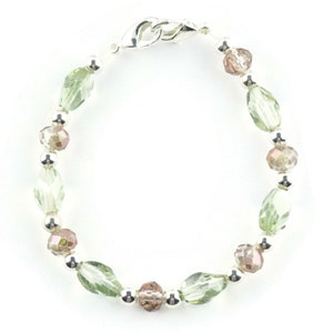 May include: A silver bracelet with green and brown crystal beads.