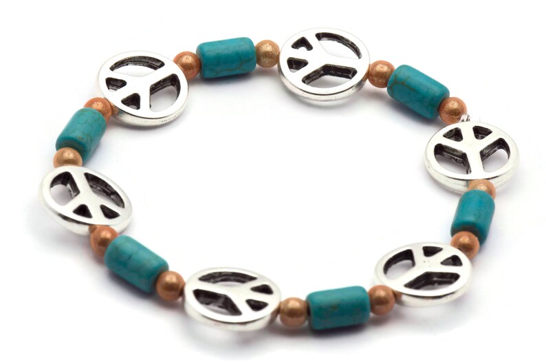 May include: A silver peace sign charm bracelet with turquoise and copper beads.