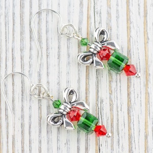 Pode incluir: Brincos de prata com um design de la&ccedil;o de cristal verde e vermelho.