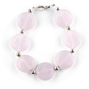 May include: A pink rose quartz bracelet with silver beads and a silver clasp.