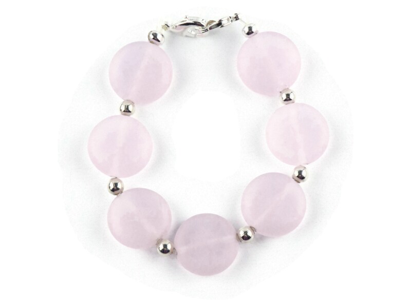 May include: A pink rose quartz bracelet with silver beads and a silver clasp.
