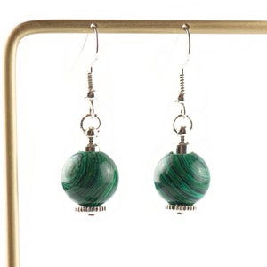 May include: A pair of silver dangle earrings with green malachite stone beads.