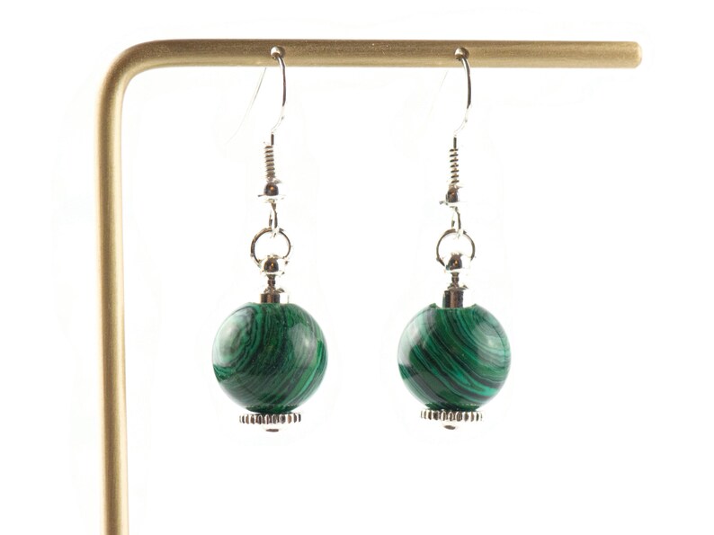 May include: A pair of silver dangle earrings with green malachite stone beads.