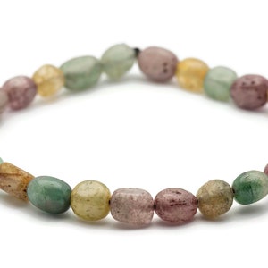 May include: A bracelet made of green, brown, and pink oval-shaped beads.