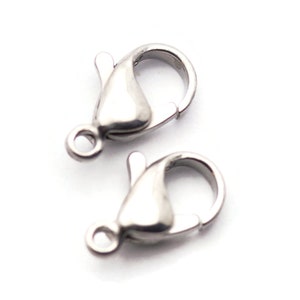 May include: Two silver-toned lobster claw clasps for jewelry making. The clasps are made of metal and have a shiny finish.