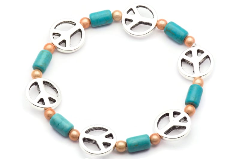 May include: A turquoise and copper beaded bracelet with silver peace sign charms.