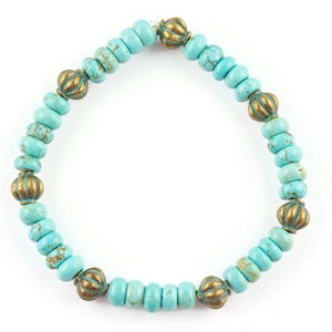 May include: Turquoise and gold beaded bracelet with a decorative design. The bracelet is made of small, round beads with a turquoise colour and gold accents.
