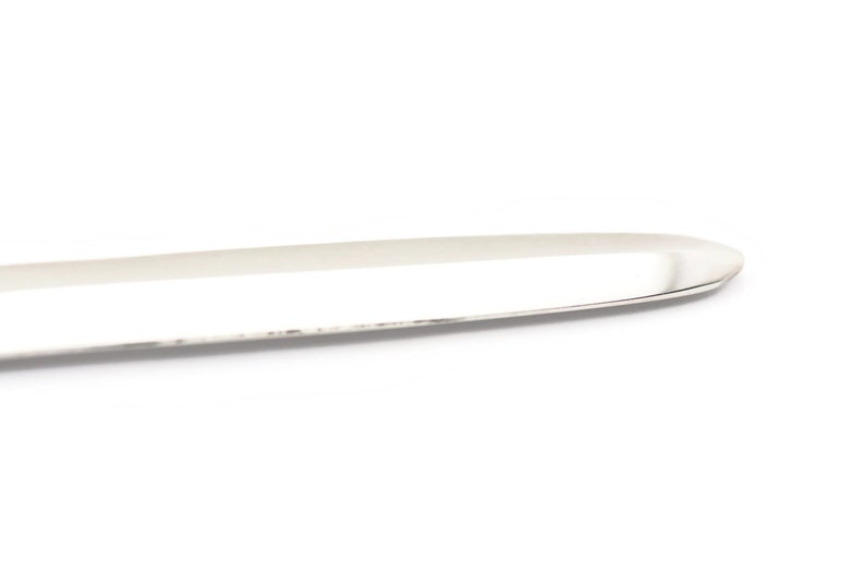 May include: A silver butter knife with a rounded tip and a smooth, polished surface.