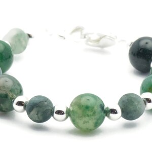 May include: A green agate gemstone bracelet with silver beads and a silver clasp.