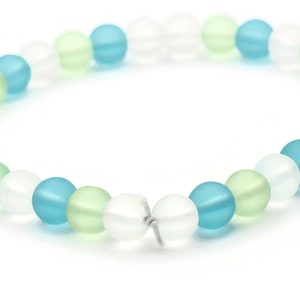 May include: A bracelet made of frosted glass beads in shades of blue, green, and white.