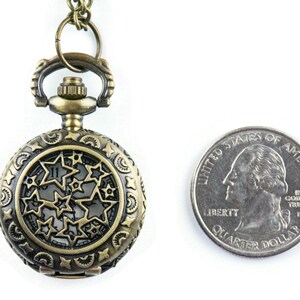 May include: A bronze pocket watch with a star-shaped design on the face. The watch is about the size of a US quarter.
