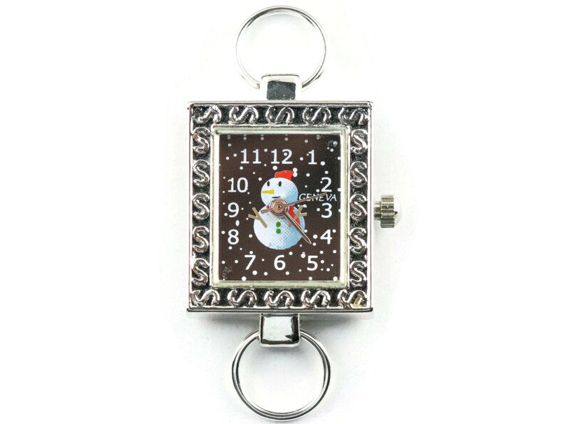 K&ouml;nnte beinhalten: Silberner Schl&uuml;sselanh&auml;nger mit Uhr, schwarzes Zifferblatt mit Schneemann-Motiv und dem Text "GENEVA".