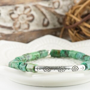 African Turquoise Stretch Bracelet on a white lotus flower shaped tray
