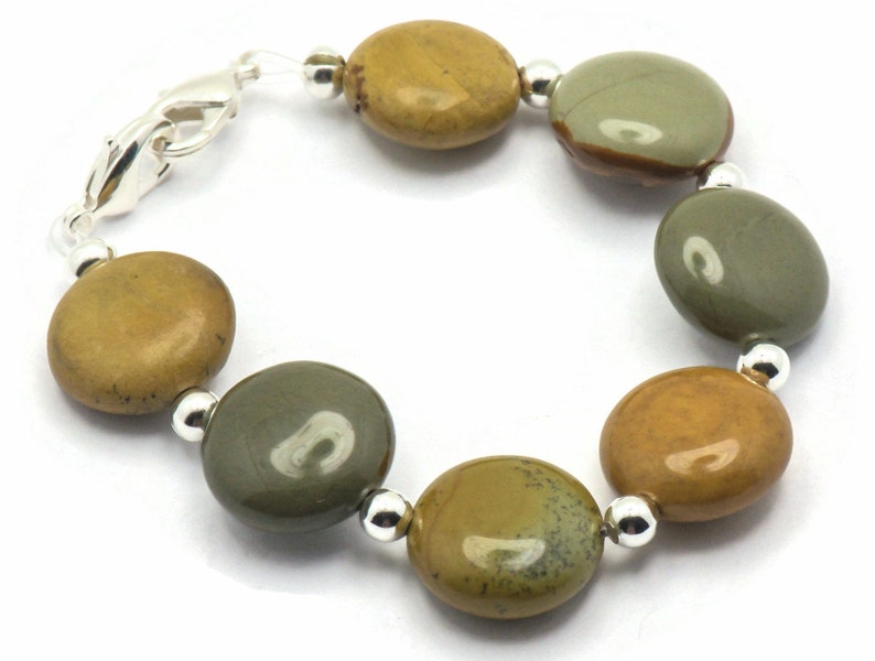 May include: A bracelet made with round, multi-colored, polished stones and silver beads.