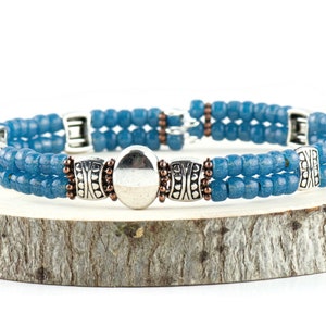 Button and Bows French Blue Cuff Memory Wire Bracelet on a wood piece with tree bark edging