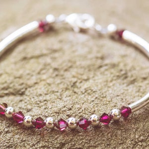 July Ruby Swarovski Crystal Birth Month Sterling Silver Plated Bracelet on stone