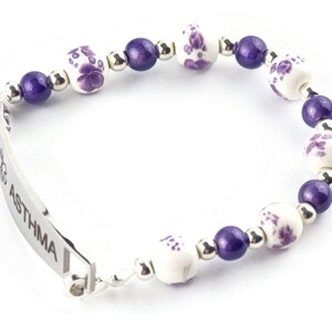 May include: A purple and white beaded bracelet with a silver medical ID tag that reads "ASTHMA".