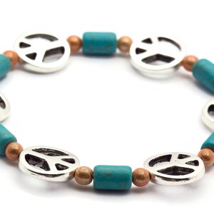 May include: A silver peace sign charm bracelet with turquoise and copper beads.