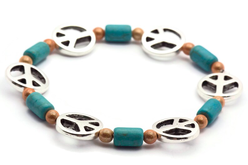 May include: A silver peace sign charm bracelet with turquoise and copper beads.