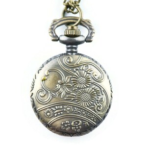 May include: A gold and silver pocket watch with a floral design on the face. The watch has a chain attached to it.