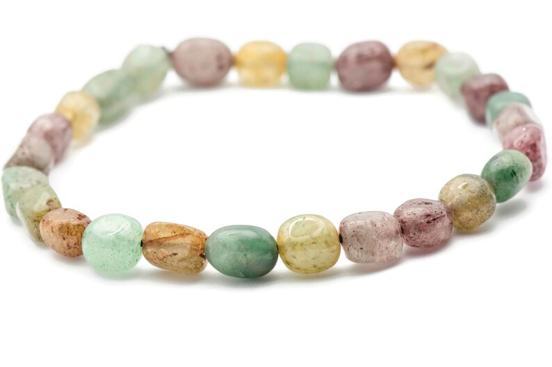 May include: A bracelet made of green, brown, and pink oval-shaped beads.