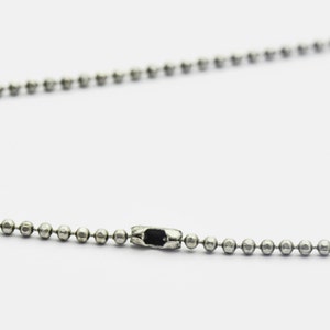 May include: A silver ball chain necklace with a silver clasp.