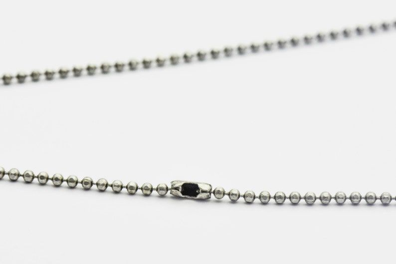 May include: A silver ball chain necklace with a silver clasp.