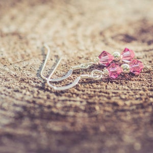 October Rose Swarovski Crystal Birth Month Sterling Silver Drop Earrings on wood background