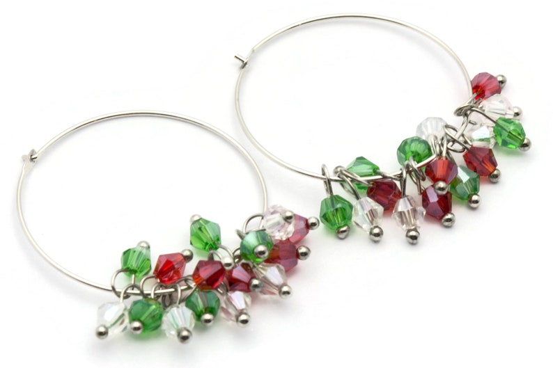 May include: Silver hoop earrings with dangling red, green, and clear crystal beads.