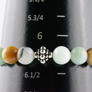 Black Gold Amazonite Genuine Gemstone Stretch Bracelet on a black bracelet mandrel size 6.25 stretch