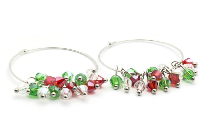 May include: Silver hoop earrings with dangling red, green, and clear crystal beads.